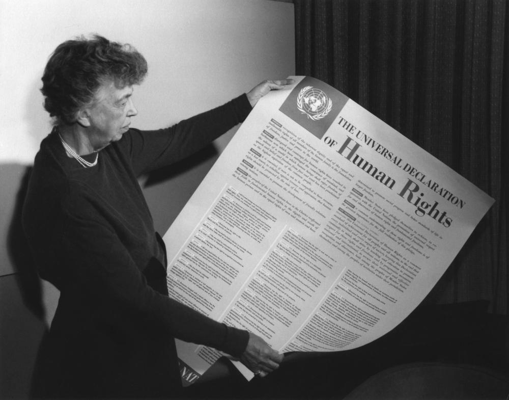 Eleanor Roosevelt holding poster of the Universal Declaration of Human Rights (in English), Lake Success, New York. November 1949