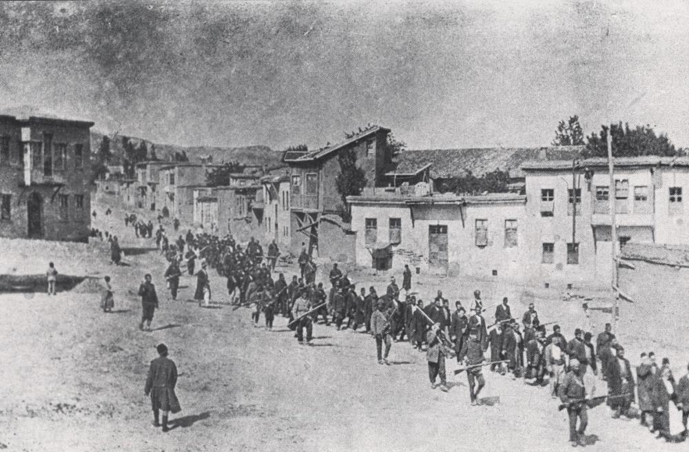 Ottoman soldiers march Armenian men from the city of Kharput to an execution site in 1915