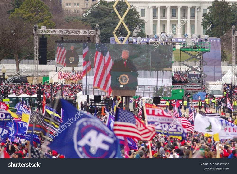  U.S. President Donald Trump appears on large screens as he speaks at the "Stop the Steal" rally at the Washington 