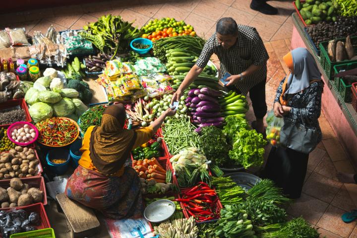 Person standing near vegetables; Siti Khatijah Market, Kelantan, Malaysia